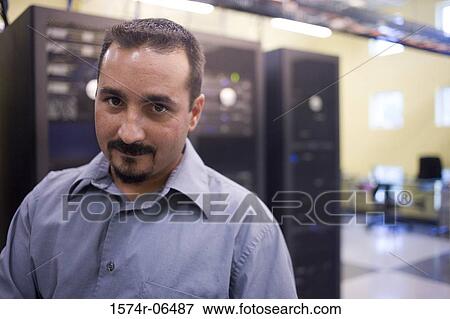 Stock Photo - Portrait of a technician in a server room. Fotosearch