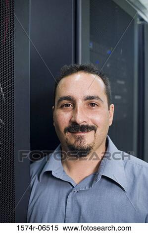 Portrait of a technician in a server room View Large Photo Image Stock Photography - Portrait of a technician in a server room. Fotosearch