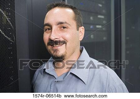 Portrait of a technician smiling in a server room View Large Photo Image Stock Image - Portrait of a technician smiling in a server room. Fotosearch
