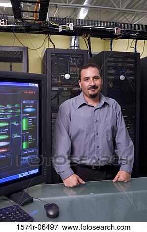 Portrait of a technician standing in a server room View Large Photo Image Stock Photo - Portrait of a technician standing in a server room. Fotosearch