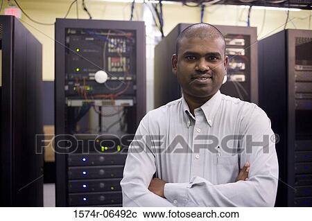 Portrait of a technician standing in front of network servers View Large Photo Image Stock Image - Portrait of a technician standing in front of network servers. Fotosearch