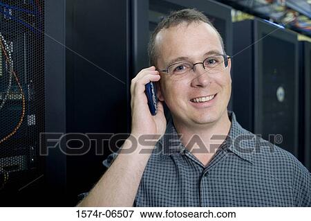 Portrait of a technician talking on a mobile phone View Large Photo Image Stock Photo - Portrait of a technician talking on a mobile phone. Fotosearch