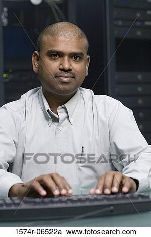 Portrait of a technician using a computer in a server room View Large Photo Image Stock Image - Portrait of a technician using a computer in a server room. Fotosearch
