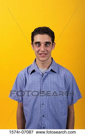 Portrait of a teenage boy making a face View Large Photo Image Stock Photo - Portrait of a teenage boy making a face. Fotosearch