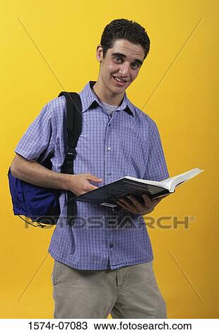 Stock Image - Portrait of a teenage boy reading a book. Fotosearch