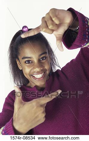 Portrait of a teenage girl making a frame View Large Photo Image Picture - Portrait of a teenage girl making a frame. Fotosearch