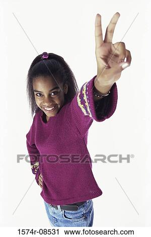 Portrait of a teenage girl making the victory sign View Large Photo Image Stock Image - Portrait of a teenage girl making the victory sign. Fotosearch