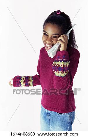 Portrait of a teenage girl talking on a telephone View Large Photo Image Stock Image - Portrait of a teenage girl talking on a telephone. Fotosearch