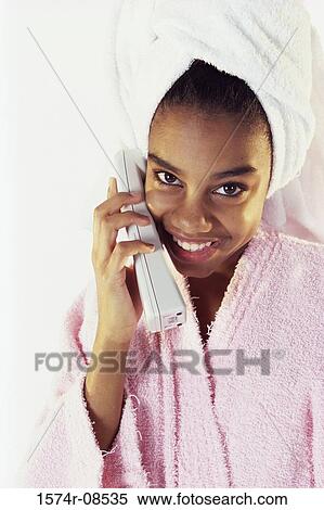 Stock Photography - Portrait of a teenage girl talking on a telephone. Fotosearch