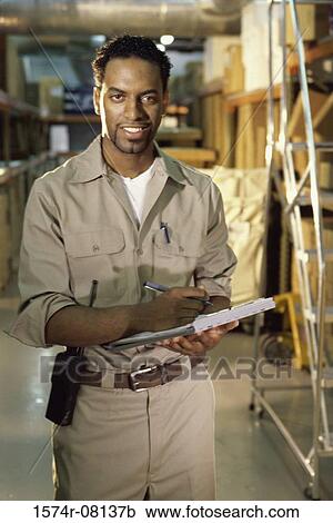 Portrait of a worker holding a clipboard smiling View Large Photo Image Stock Image - Portrait of a worker holding a clipboard smiling. Fotosearch