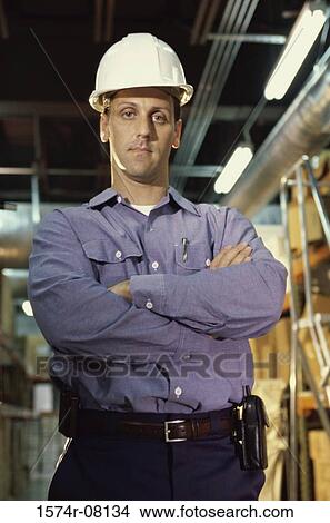 Picture - Portrait of a worker wearing a hardhat. Fotosearch