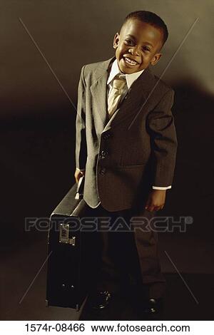 Portrait of a young boy dressed as a businessman smiling View Large Photo Image Stock Photograph - Portrait of a young boy dressed as a businessman smiling. Fotosearch