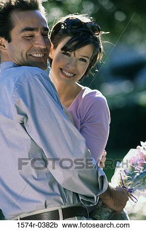 Stock Image - Portrait of a young couple smiling. Fotosearch