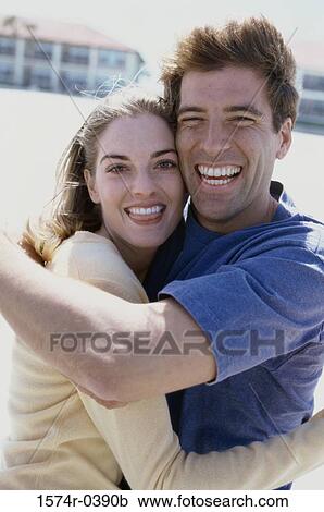 Stock Image - Portrait of a young couple smiling. Fotosearch