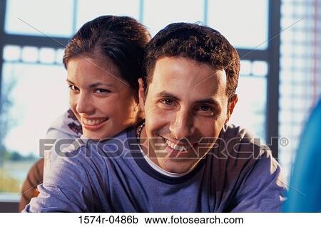 Stock Image - Portrait of a young couple smiling. Fotosearch