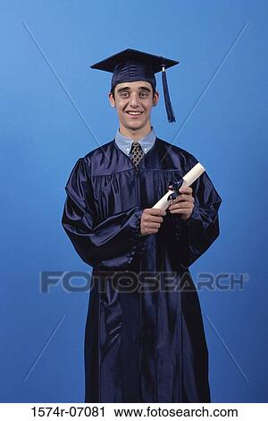Portrait of a young male graduate holding a diploma View Large Photo Image Stock Image - Portrait of a young male graduate holding a diploma. Fotosearch