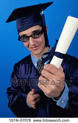 Portrait of a young male graduate holding a diploma View Large Photo Image Stock Photograph - Portrait of a young male graduate holding a diploma. Fotosearch