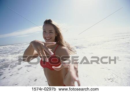 Portrait of a young woman laughing at the beach View Large Photo Image Stock Image - Portrait of a young woman laughing at the beach. Fotosearch
