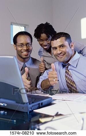 Stock Image - Portrait of business executives making the thumbs up sign. Fotosearch