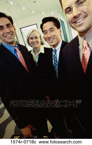 Stock Image - Portrait of business executives smiling. Fotosearch