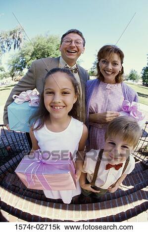 Stock Image - Portrait of parents standing with their son and daughter. Fotosearch