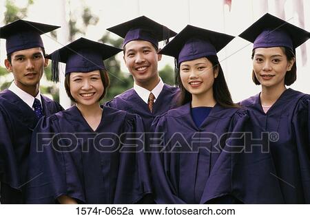 Stock Image - Portrait of three female graduates and two male graduates smiling. Fotosearch