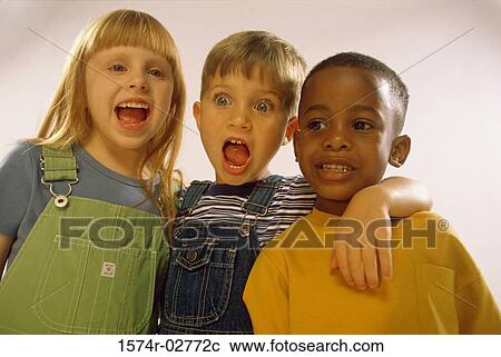 Stock Image - Portrait of two boys and a girl holding each other. Fotosearch