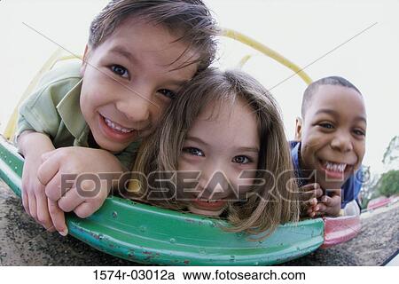 Portrait of two boys and a girl playing View Large Photo Image Stock Image - Portrait of two boys and a girl playing. Fotosearch