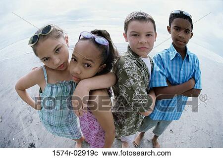 Portrait of two boys and two girls standing on the beach View Large Photo Image Stock Image - Portrait of two boys and two girls standing on the beach. Fotosearch