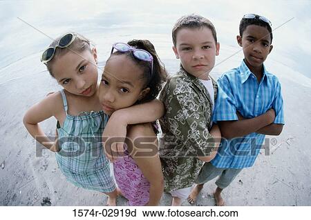 Portrait of two boys and two girls standing on the beach View Large Photo Image Stock Image - Portrait of two boys and two girls standing on the beach. Fotosearch