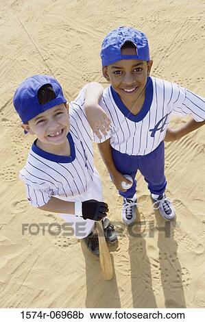 Stock Image - Portrait of two boys in baseball uniforms. Fotosearch