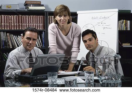 Portrait of two businessmen and a businesswoman in an office View Large Photo Image Picture - Portrait of two businessmen and a businesswoman in an office. Fotosearch