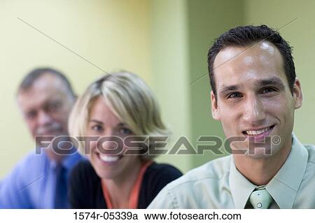 Portrait of two businessmen and a businesswoman in an office View Large Photo Image Stock Image - Portrait of two businessmen and a businesswoman in an office. Fotosearch