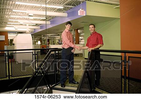 Portrait of two businessmen shaking hands in an office View Large Photo Image Stock Image - Portrait of two businessmen shaking hands in an office. Fotosearch