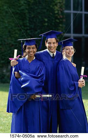 Stock Image - Portrait of two female graduates and a male graduate holding diplomas. Fotosearch
