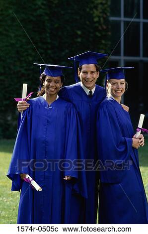 Stock Image - Portrait of two female graduates and a male graduate holding diplomas. Fotosearch