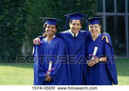 Stock Image - Portrait of two female graduates and a male graduate holding diplomas. Fotosearch