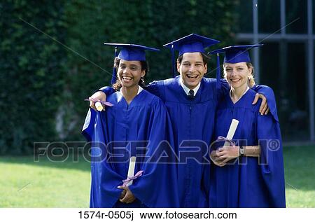 Stock Image - Portrait of two female graduates and a male graduate holding diplomas. Fotosearch