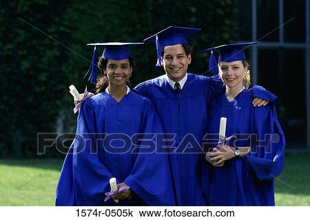Stock Image - Portrait of two female graduates and a male graduate holding diplomas. Fotosearch