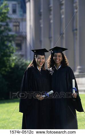 Portrait of two female graduates holding diplomas View Large Photo Image Stock Image - Portrait of two female graduates holding diplomas. Fotosearch