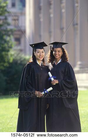 Portrait of two female graduates holding diplomas View Large Photo Image Stock Image - Portrait of two female graduates holding diplomas. Fotosearch