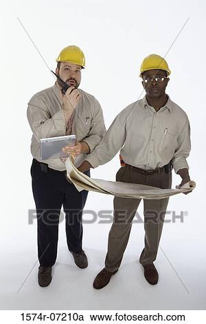 Stock Image - Portrait of two foremen working on blueprints. Fotosearch