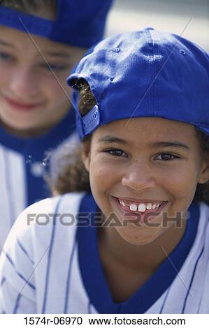 Portrait of two girls in baseball uniforms smiling View Large Photo Image Stock Image - Portrait of two girls in baseball uniforms smiling. Fotosearch