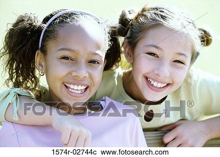 Portrait of two girls smiling View Large Photo Image Stock Image - Portrait of two girls smiling. Fotosearch