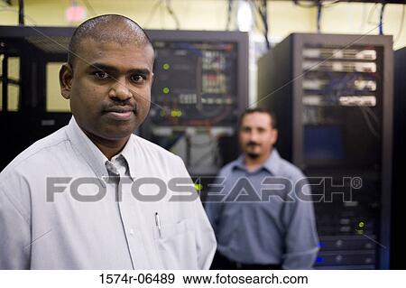 Stock Photo - Portrait of two technicians in a server room. Fotosearch