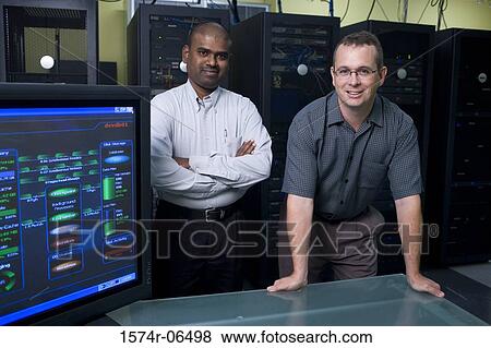 Stock Photo - Portrait of two technicians standing in a server room. Fotosearch