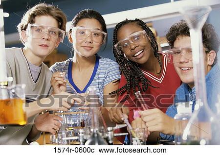Stock Image - Portrait of two teenage boys and two teenage girls in a science laboratory. Fotosearch