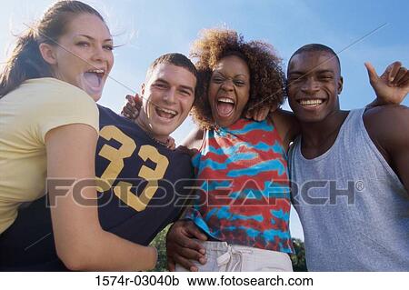 Portrait of two young couples smiling together View Large Photo Image Stock Image - Portrait of two young couples smiling together. Fotosearch