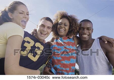 Portrait of two young couples smiling together View Large Photo Image Stock Image - Portrait of two young couples smiling together. Fotosearch
