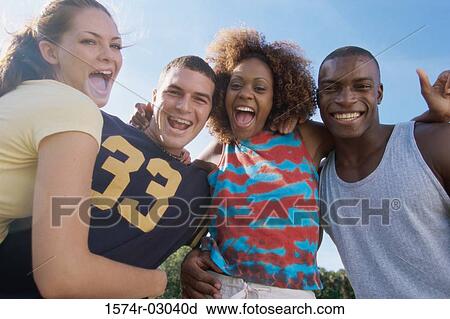 Portrait of two young couples smiling together View Large Photo Image Stock Image - Portrait of two young couples smiling together. Fotosearch